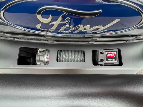 Ford grille emblem and integrated front warning lights close-up.